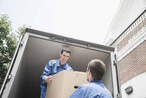 Movers carrying household items from a flat in Lambeth